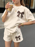 Girls' Apricot Two Piece Shorts Set with Leopard Bow Graphics and a Short Sleeve Crew Neck Top